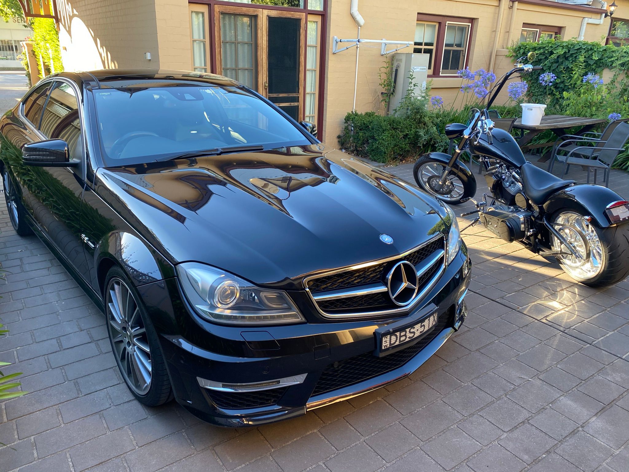 Black Mercedes and custom motorcycle