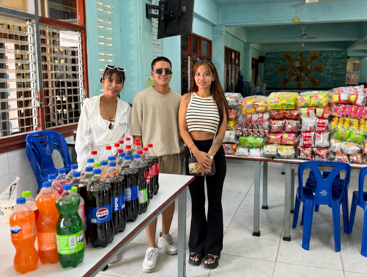 Charity volunteers with donated food and drinks in Thailand